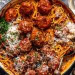 Spicy turkey meatballs served on top of spaghetti topped with parmesan cheese, chopped parsley and red pepper flakes.