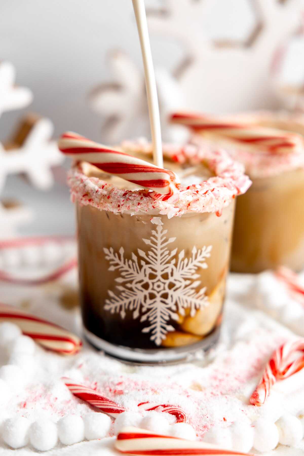 Heavy cream being poured into a candy cane white russian. 