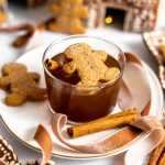 A gingerbread cocktail with a gingerbread cookie garnish.