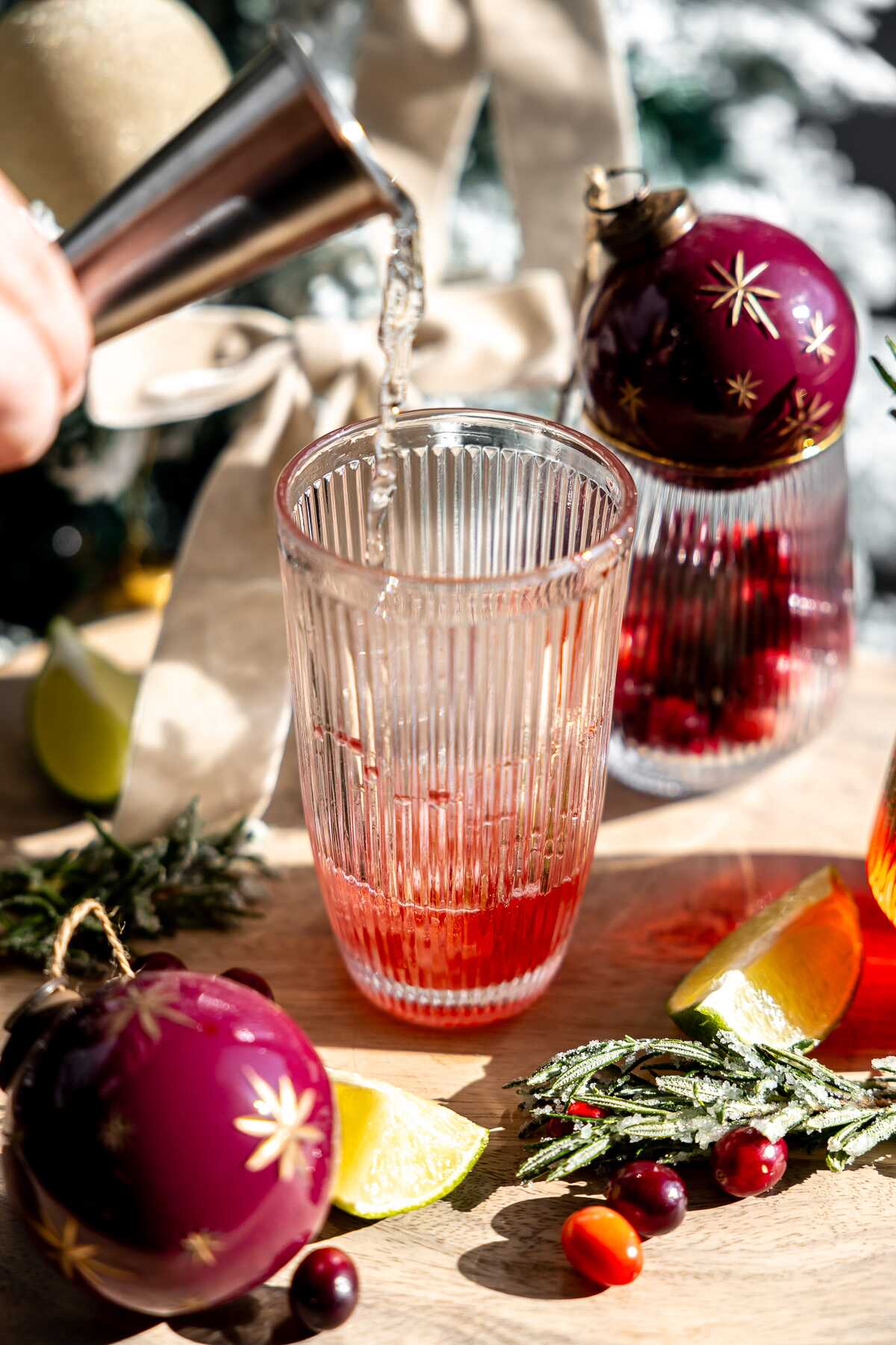 Tequila being poured into a cocktail shaker. 