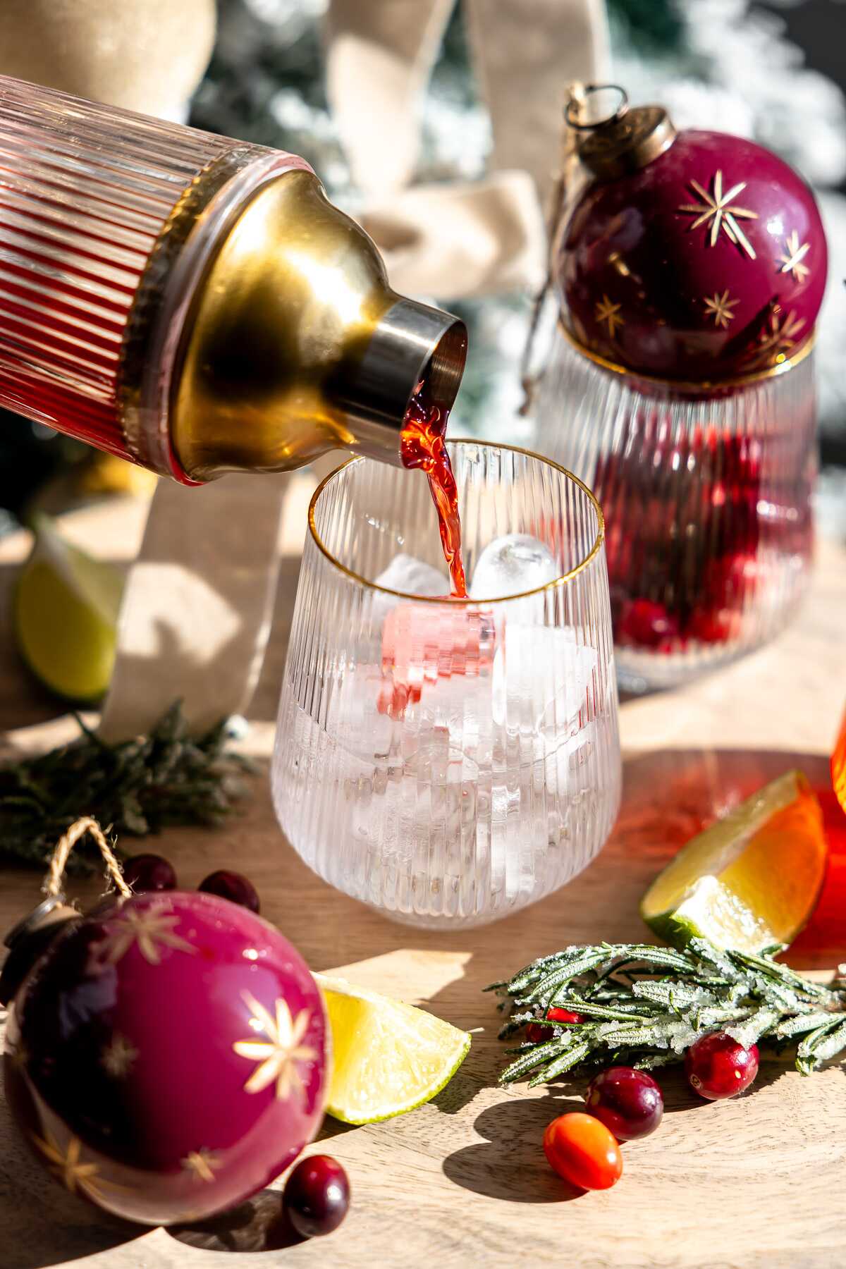 Mistletoe margarita being poured into a glass over ice. 