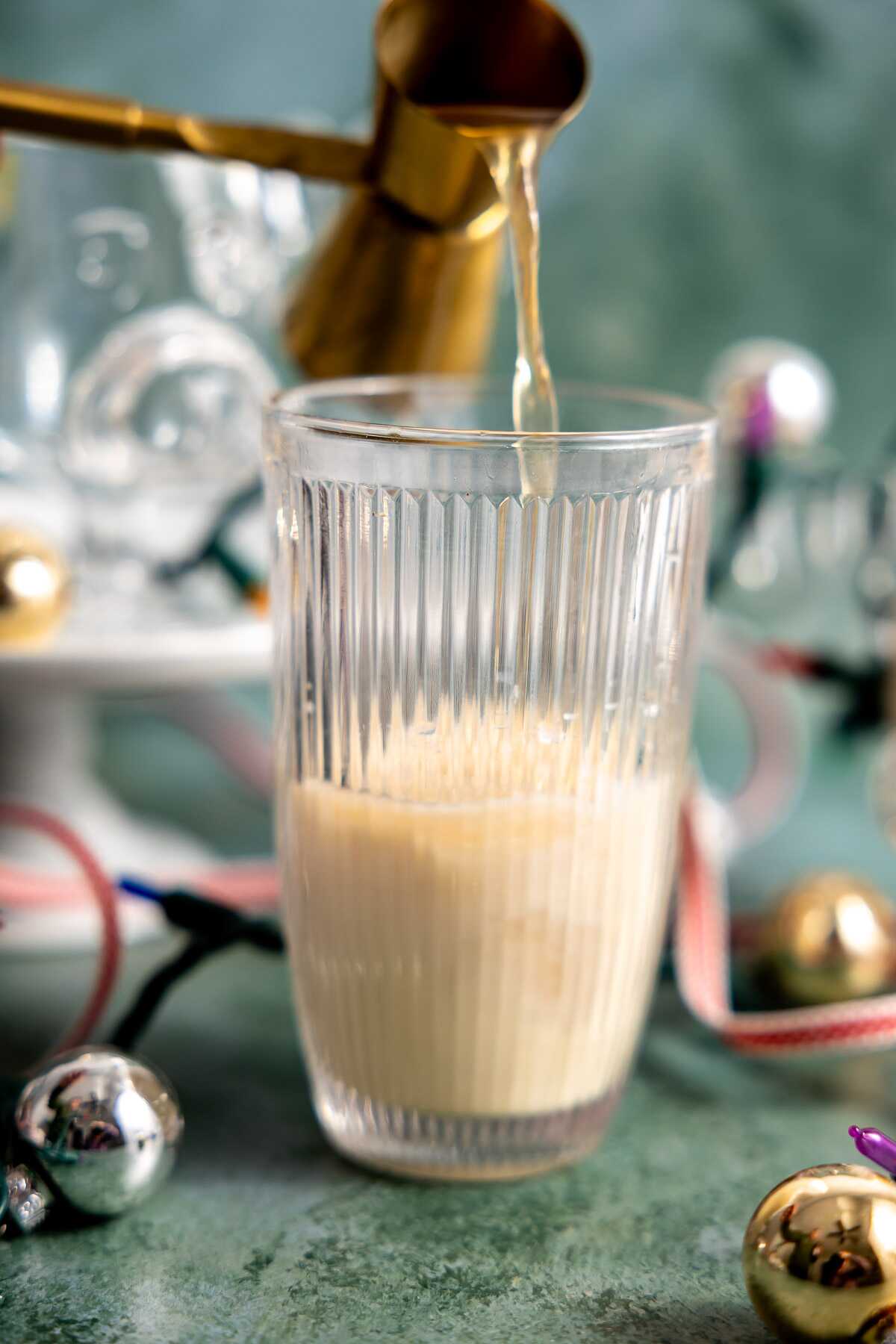 Spiced rum being poured into a cocktail shaker.