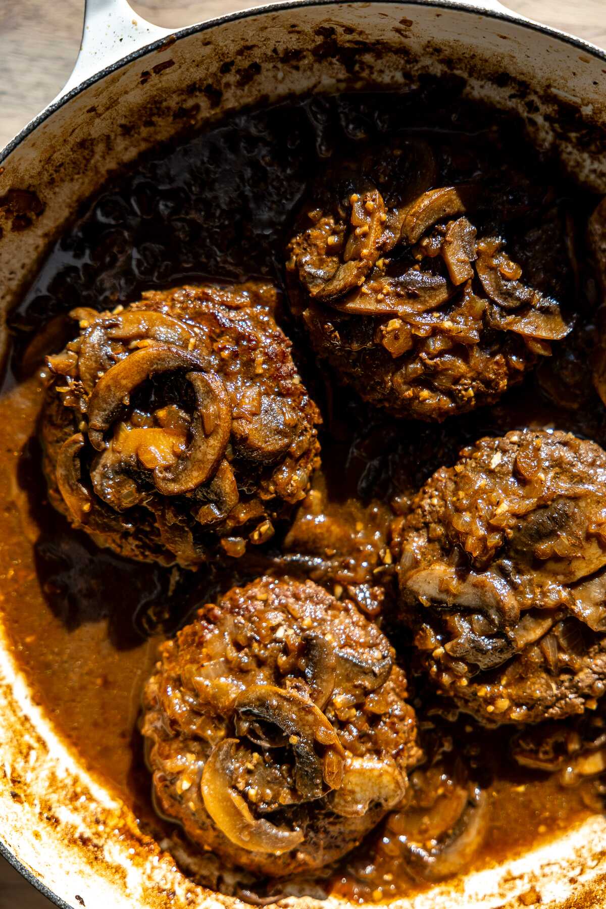 Easy salisbury steaks simmered in a decadent brown gravy with mushrooms.