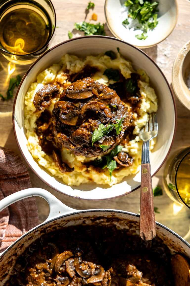 Easy salisbury steak served over a bed of mashed potatoes.