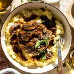 Easy salisbury steak served over a bed of mashed potatoes.